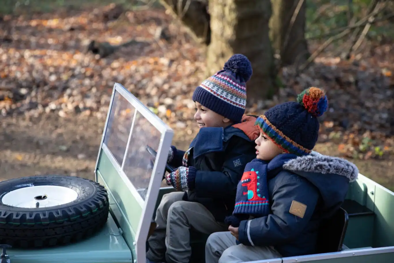 Kids in a mini Land Rover car